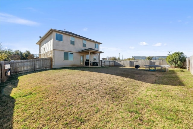 rear view of property with a yard