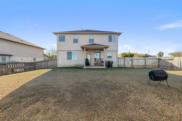 rear view of house with a lawn and a patio