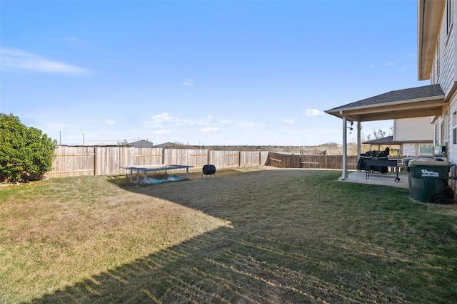 view of yard featuring a trampoline and a patio