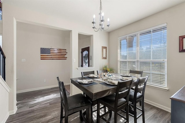 dining room with dark hardwood / wood-style floors and a chandelier