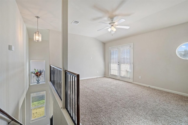 unfurnished room featuring vaulted ceiling, carpet flooring, and ceiling fan