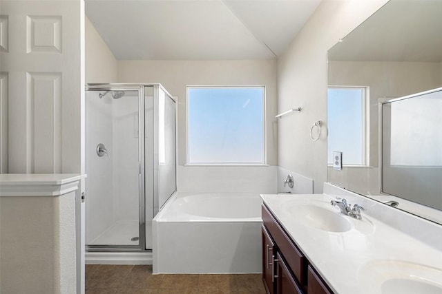 bathroom with tile patterned floors, vanity, and plus walk in shower