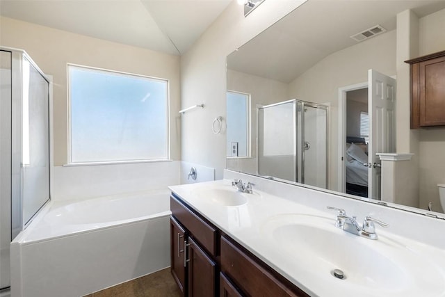 full bathroom featuring shower with separate bathtub, vanity, and toilet