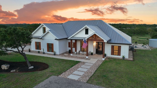 modern farmhouse with a lawn