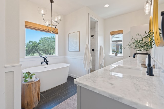 bathroom with vanity, a notable chandelier, and independent shower and bath