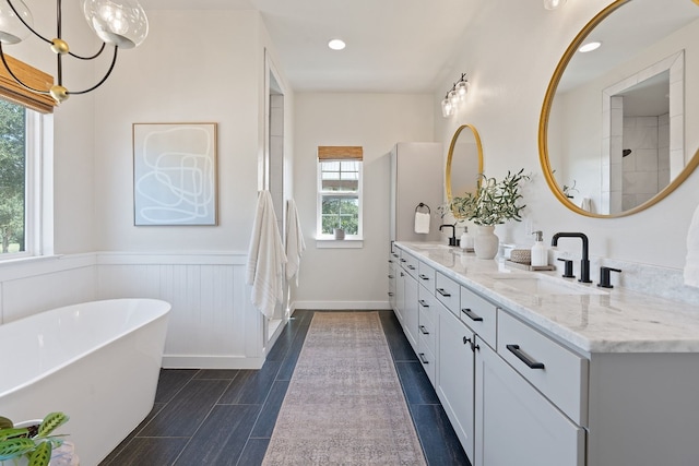 bathroom with vanity and independent shower and bath