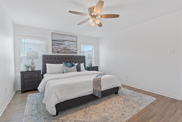 bedroom with ceiling fan and light hardwood / wood-style flooring