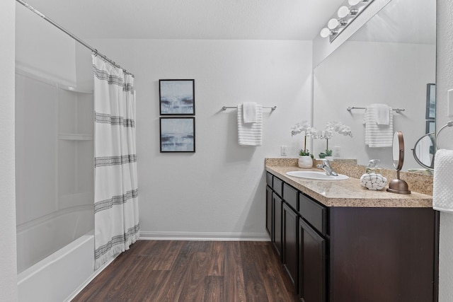 bathroom with vanity, wood-type flooring, shower / bath combination with curtain, and a textured ceiling