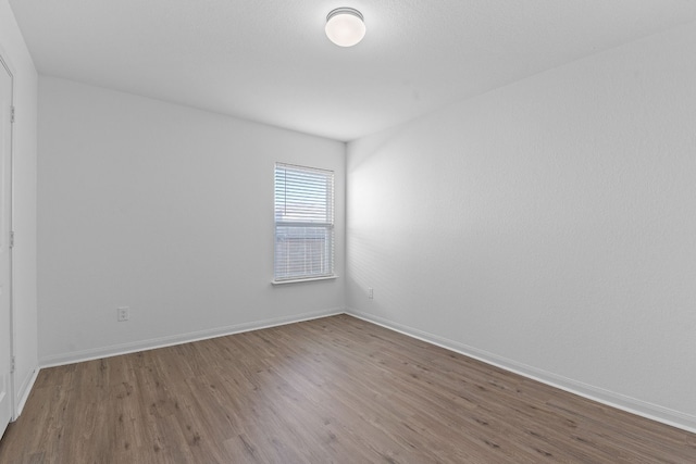 empty room featuring hardwood / wood-style flooring