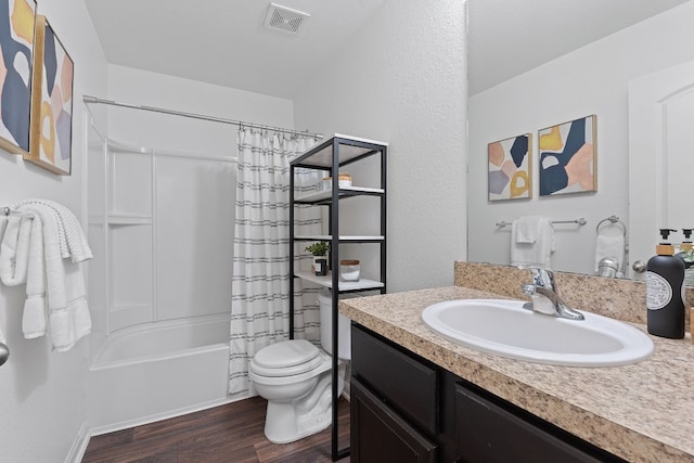 full bathroom featuring hardwood / wood-style flooring, vanity, toilet, and shower / tub combo