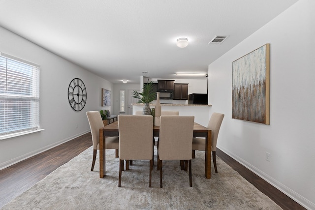 dining area featuring dark wood-type flooring