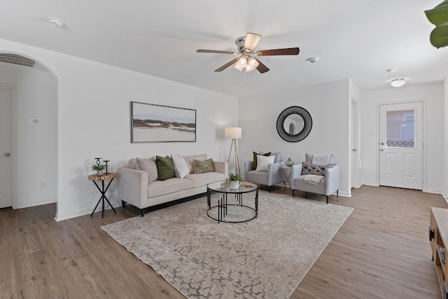 living room featuring ceiling fan and hardwood / wood-style floors