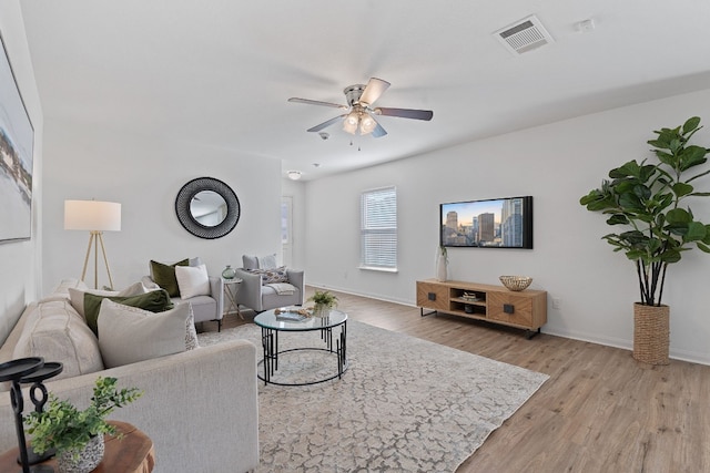 living room featuring ceiling fan and light wood-type flooring