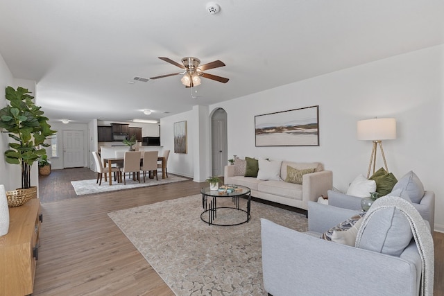 living room featuring hardwood / wood-style flooring and ceiling fan