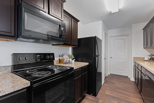 kitchen with dark brown cabinetry, dark hardwood / wood-style flooring, a textured ceiling, and black appliances