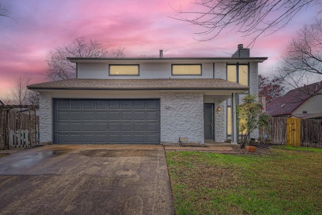 view of property with a garage and a yard