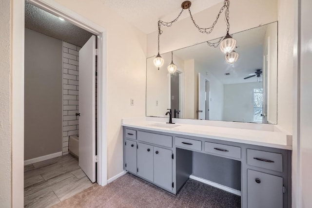 bathroom featuring vanity, a textured ceiling, bathing tub / shower combination, and ceiling fan