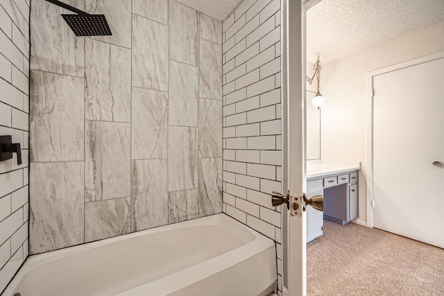 bathroom featuring vanity, tiled shower / bath combo, and a textured ceiling