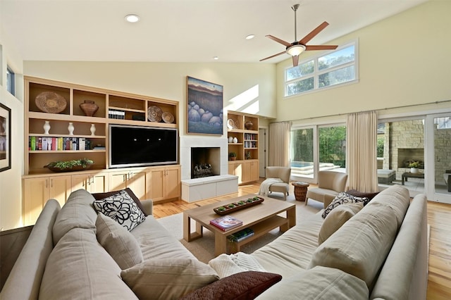 living room featuring high vaulted ceiling, ceiling fan, and light hardwood / wood-style flooring