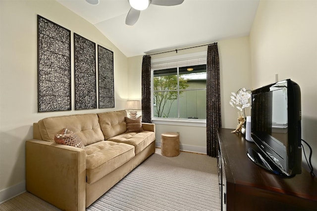 living area with lofted ceiling, ceiling fan, and carpet