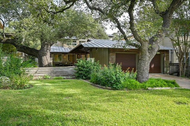 view of front of house with a garage and a front lawn