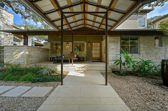 view of exterior entry featuring a patio area