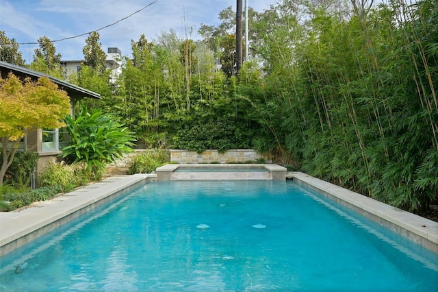 view of pool with an in ground hot tub