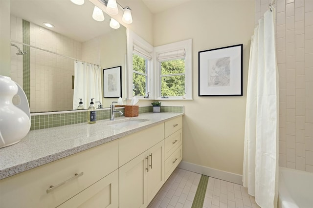 bathroom with vanity, shower / bathtub combination with curtain, and tile patterned flooring