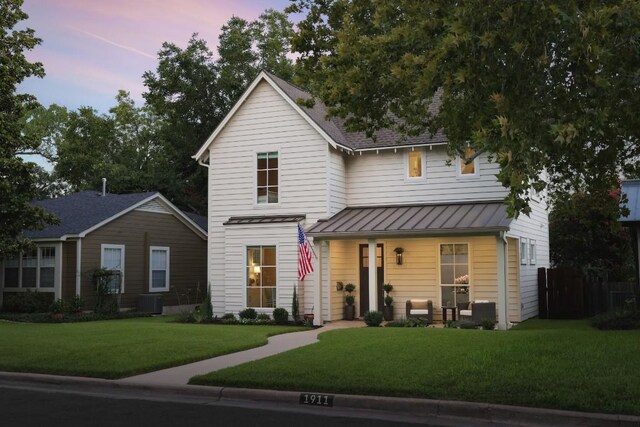 view of front of property featuring a lawn and a porch