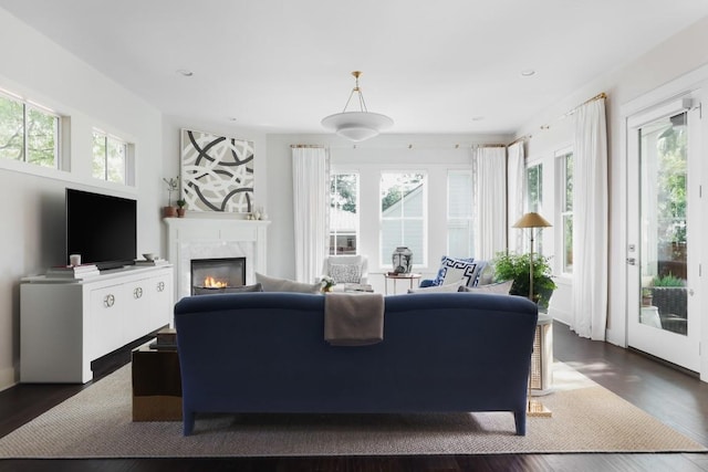 1911 W 36th St, Austin, TX 78731 - living room featuring a high end fireplace, dark wood-style flooring, and recessed lighting