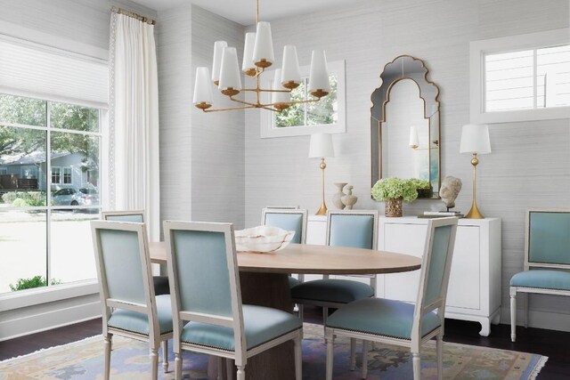 1911 W 36th St, Austin, TX 78731 - dining space with a chandelier, wood finished floors, and wallpapered walls