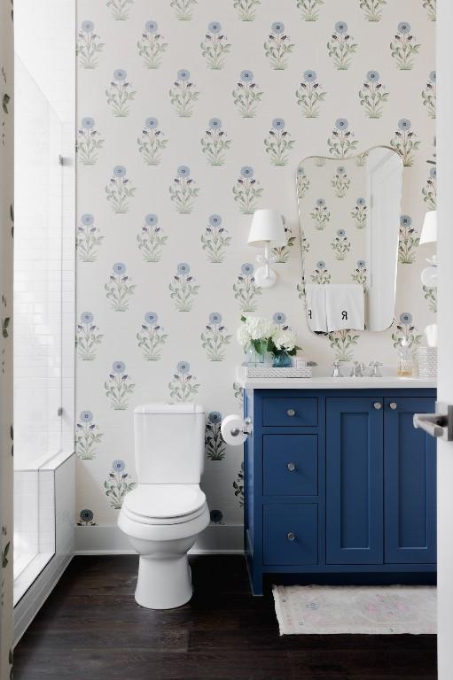 1911 W 36th St, Austin, TX 78731 - full bathroom featuring baseboards, wood finished floors, vanity, wallpapered walls, and toilet
