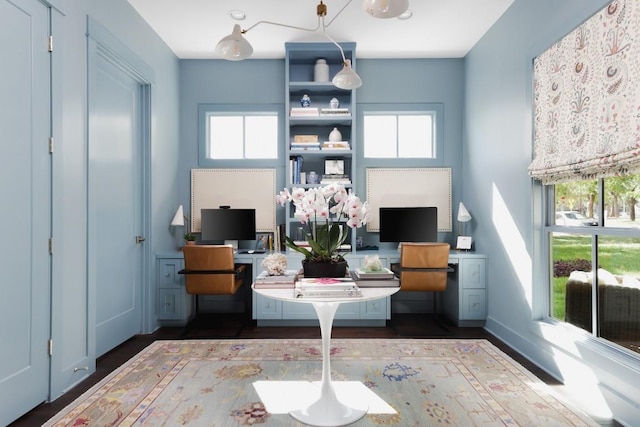 home office featuring dark wood-style floors, baseboards, and a healthy amount of sunlight