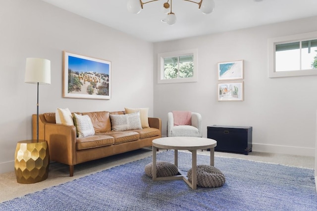 1911 W 36th St, Austin, TX 78731 - living room with a chandelier, carpet flooring, and baseboards