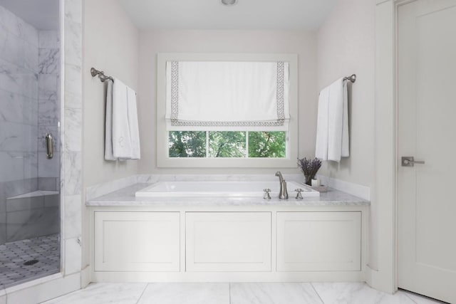 full bath featuring a garden tub, marble finish floor, and a shower stall