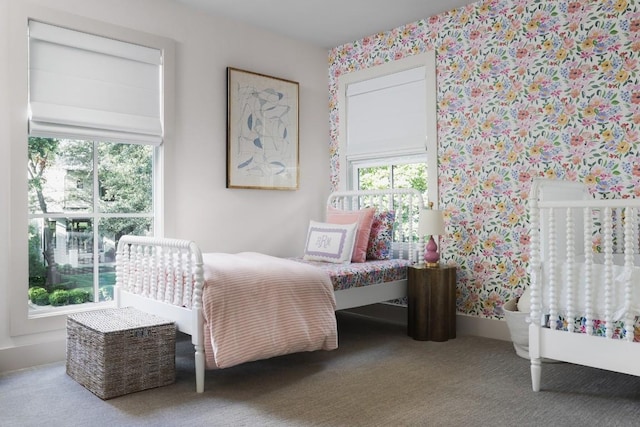 bedroom with carpet floors, multiple windows, and wallpapered walls