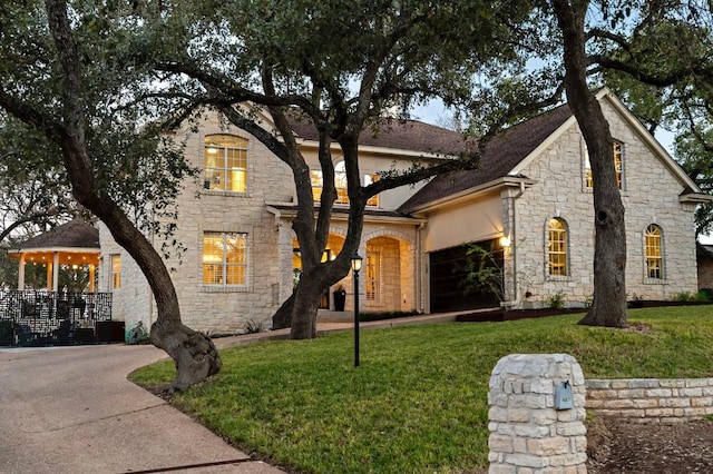 french country inspired facade with a garage and a front yard