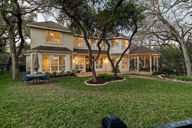 rear view of property with a yard and a patio area