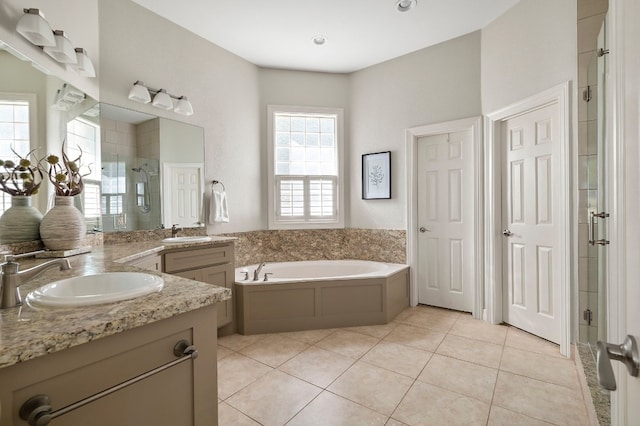 bathroom with tile patterned flooring, vanity, and independent shower and bath