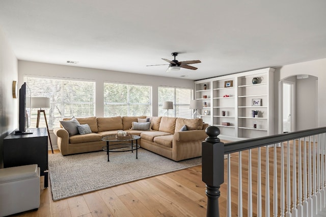 living room with hardwood / wood-style floors and ceiling fan