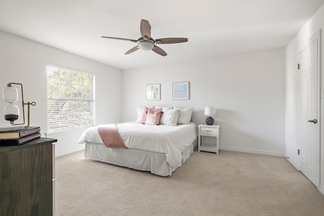 bedroom featuring light carpet and ceiling fan