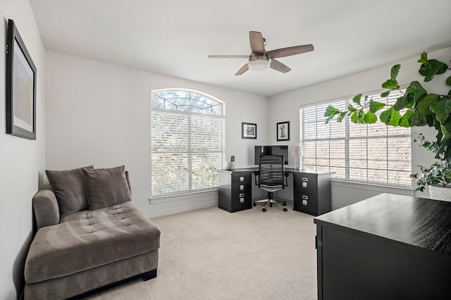 office area featuring light carpet and ceiling fan