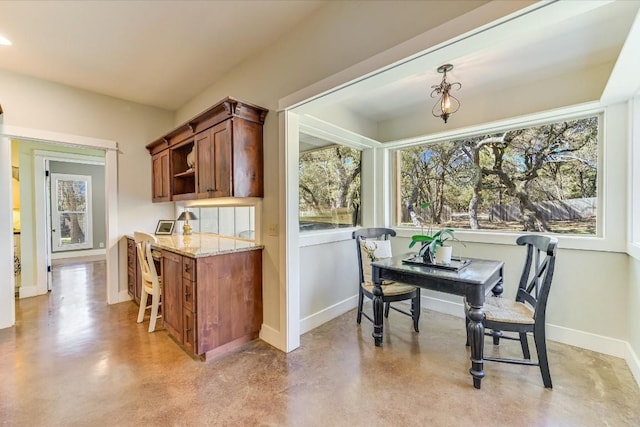 kitchen featuring pendant lighting and light stone counters