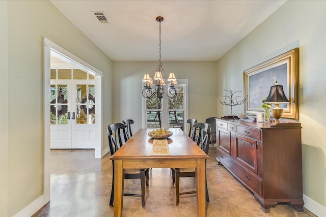 dining space featuring a notable chandelier and french doors