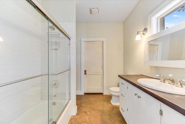 full bathroom with toilet, vanity, and bath / shower combo with glass door