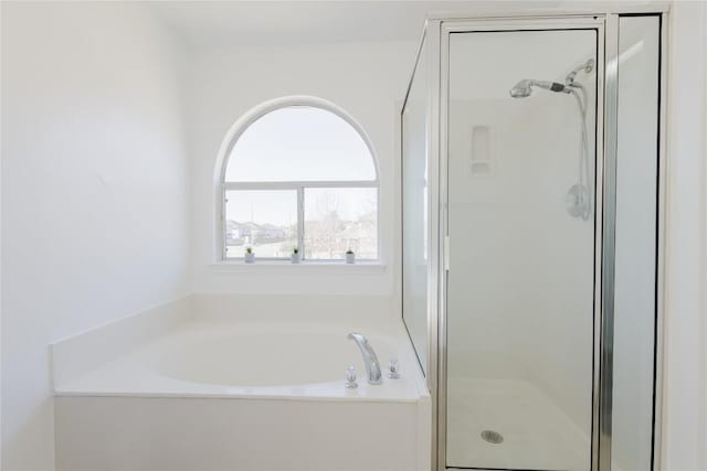 bathroom featuring separate shower and tub