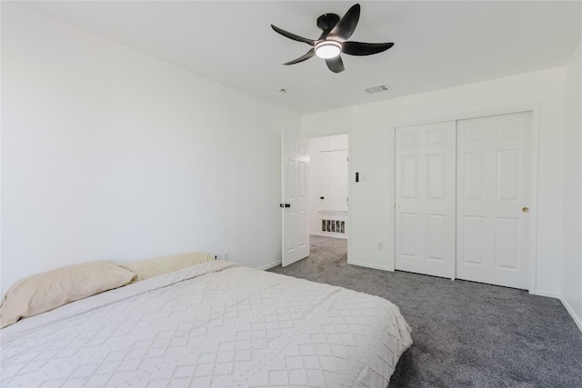 bedroom with dark carpet, a closet, and ceiling fan