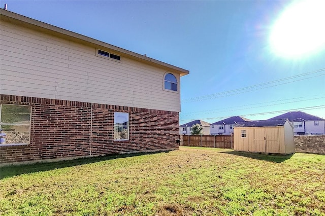 view of home's exterior with a lawn and a storage unit