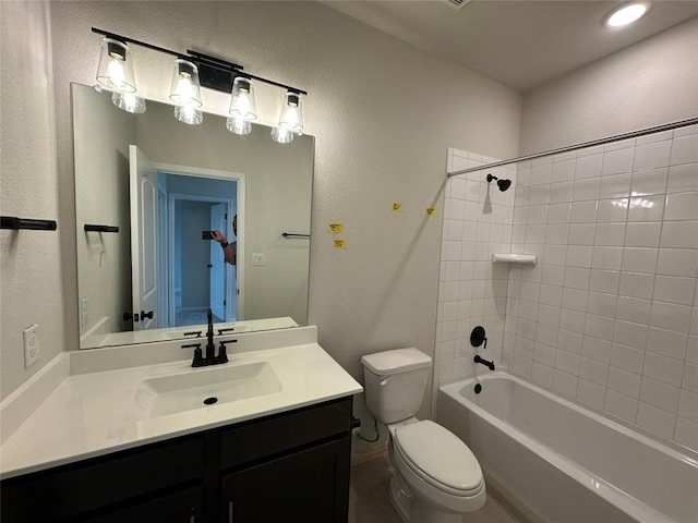 full bathroom featuring toilet, vanity, and shower / bathing tub combination