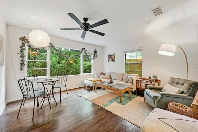 living room featuring ceiling fan and dark hardwood / wood-style floors